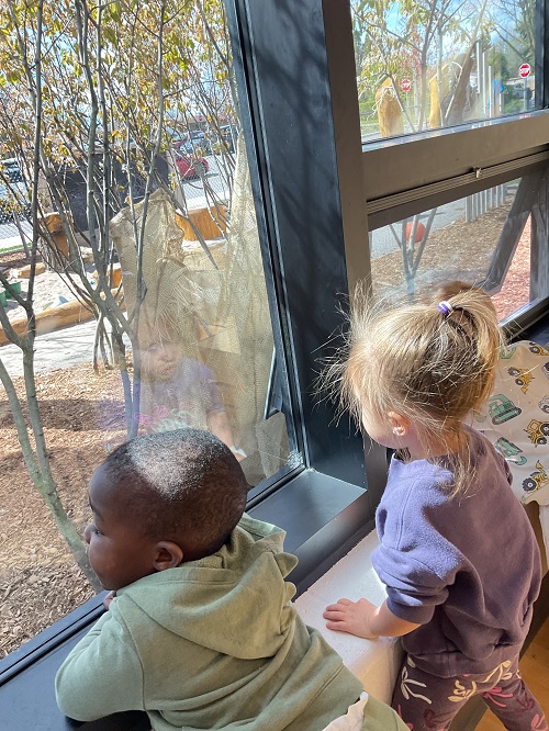 children observing from the window