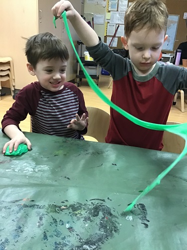 Children exploring green slime