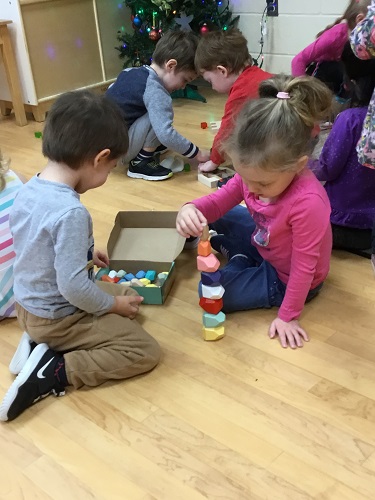 Children exploring the new classroom toys