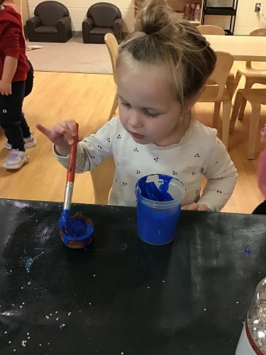 A child painting her Diya blue