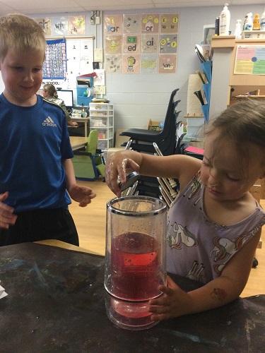 Experimenting by adding coloured hot water to a jar of cold water