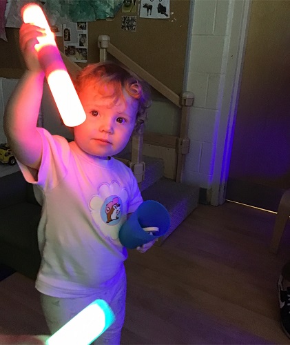 A child holding up a light stick