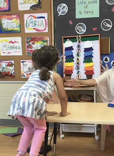A child looking at the colours on a felt ice cream