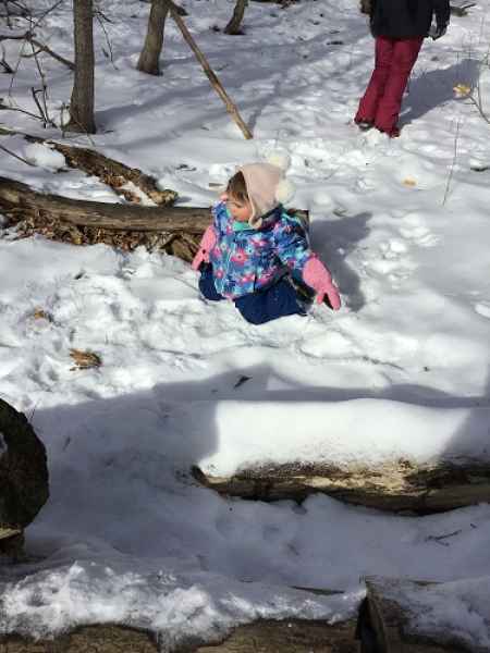 girl playing in a the snow