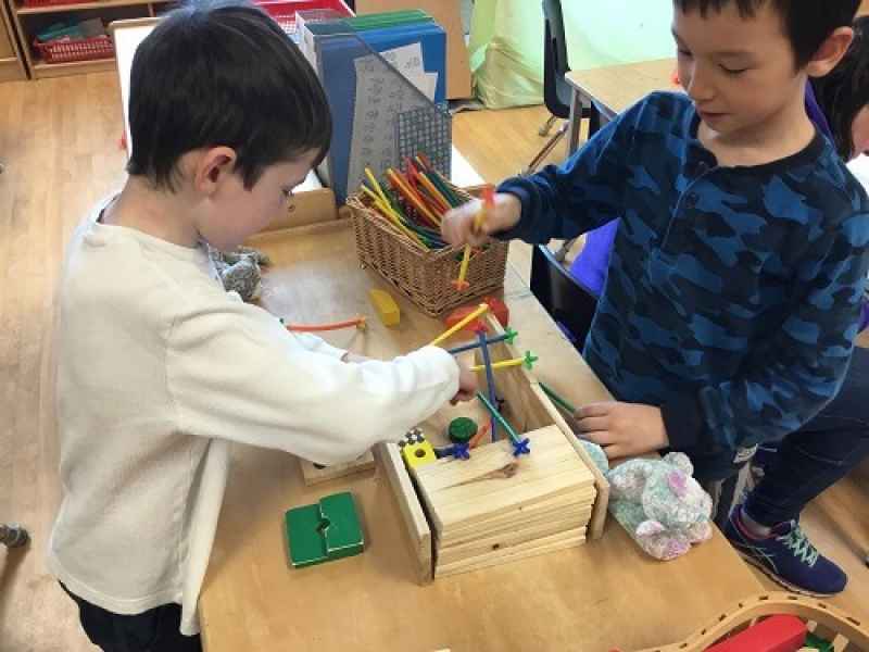 boys playing with connecter sticks