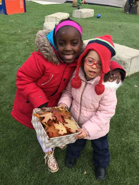 girls collecting leaves outside