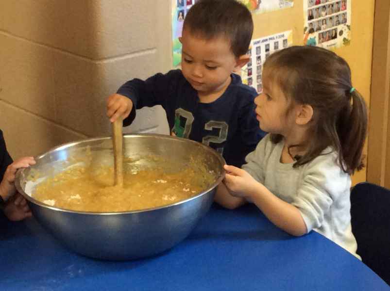 preschoolers mixing batter