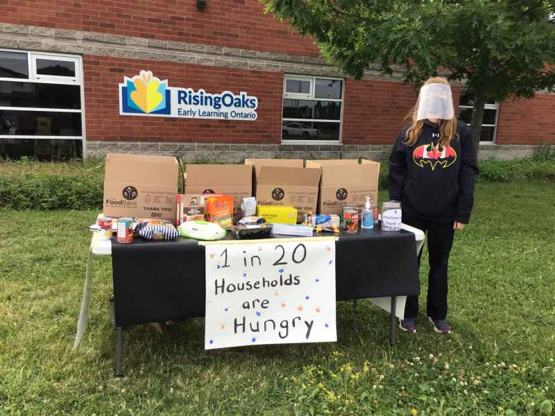 food drive table set up with signs and donation boxes