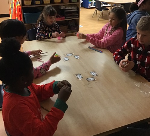 six children sitting around a table