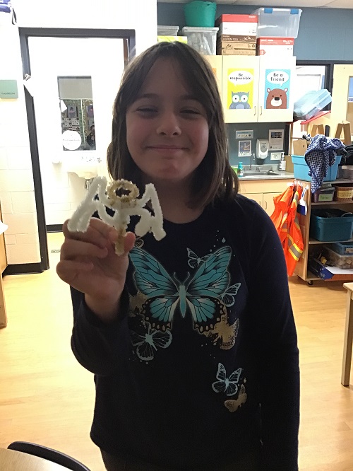 child holding up a crystalized salt creation