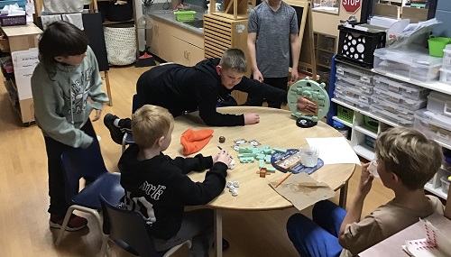 children around a table playing games