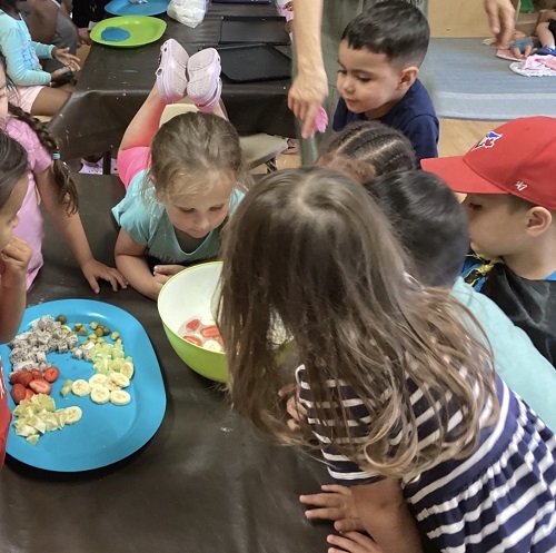 children waiting to taste test fruit