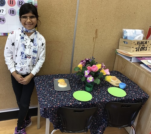 proud child beside her table setting