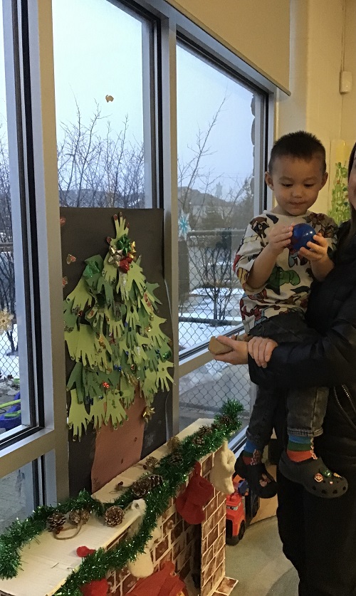 Child and parent at christmas tree