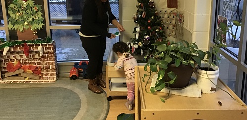 Child and parent decorating the tree