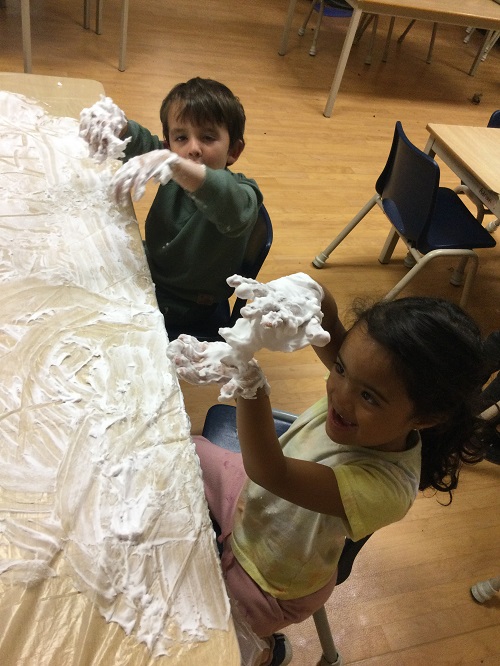 2 children showing off their messy hands