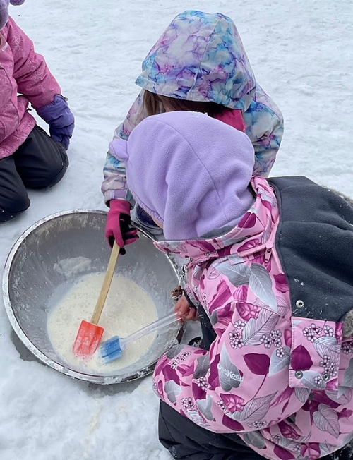 The JKK after school classroom from RisingOaks Early Learning | St. Patrick made vanilla ice cream outside in the snow.