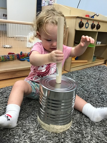 Child placing object in can