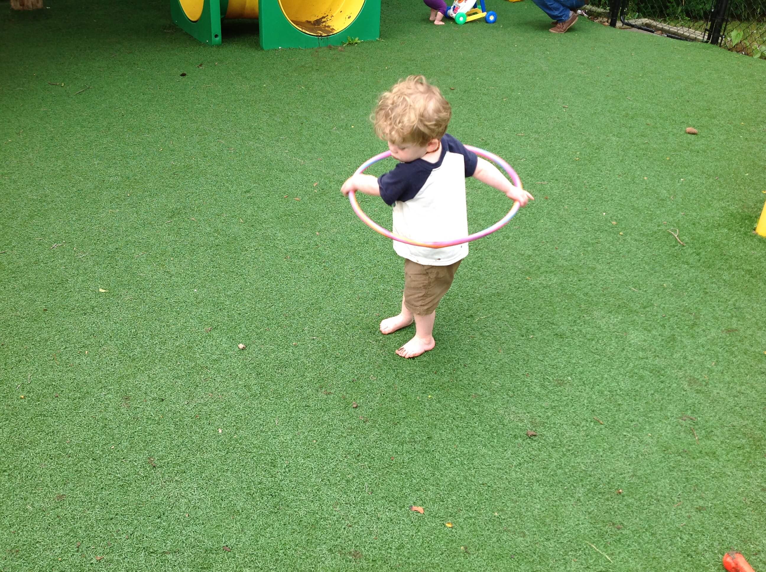 child using a hula hoop