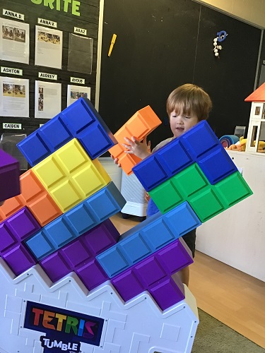 Preschool child playing giant tetras game