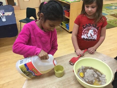 Measuring oil into cup for batter 