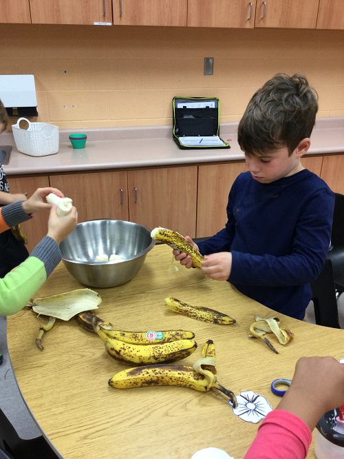 Child peeling bananas