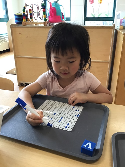 Child searching for letters in a wordsearch