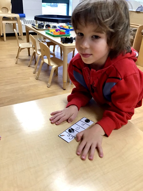 Child showing off their letter strip