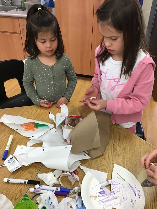 children working hard to create their structure