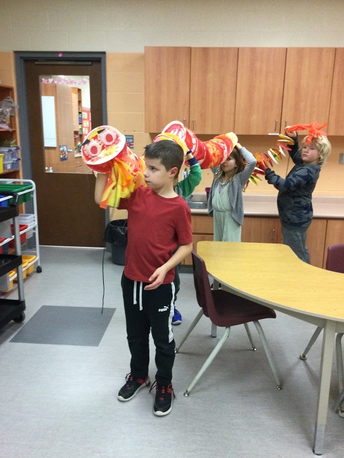 children holding their Chinese Dragon