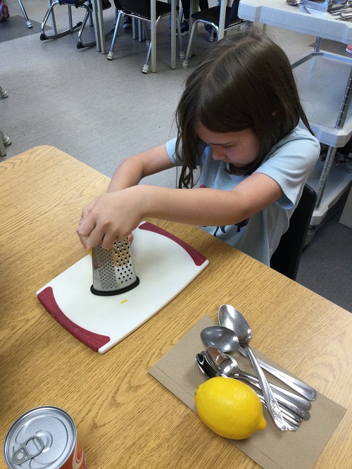 child grating a lemon