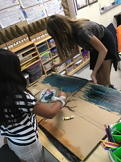 two children painting a picture