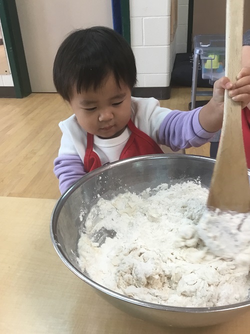 child mixing the batter with a spoon