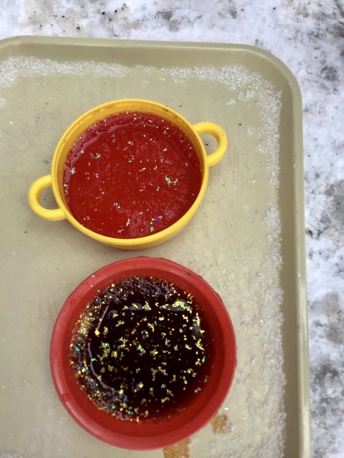 Frozen water in bowls on the playground