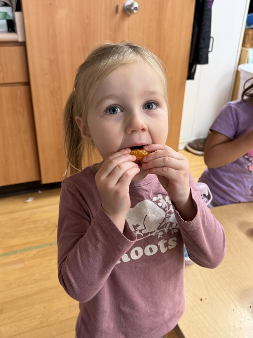 child trying the fruit