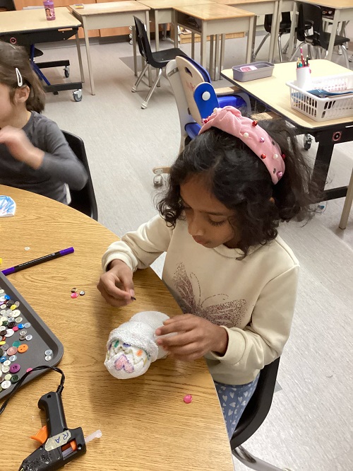 putting gems onto snow person