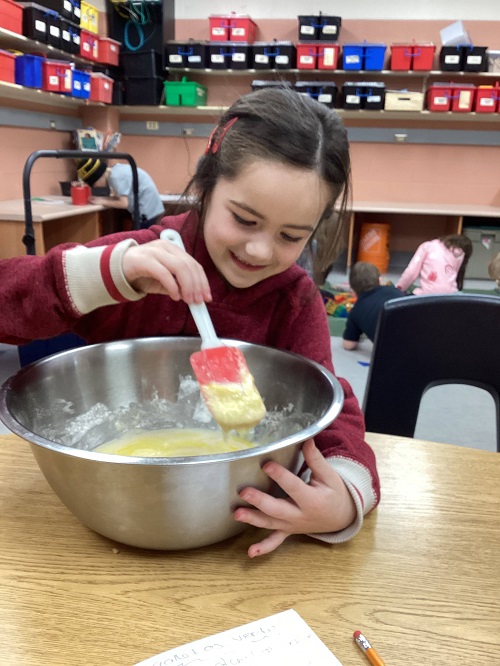 child mixing ingredients in a bowl