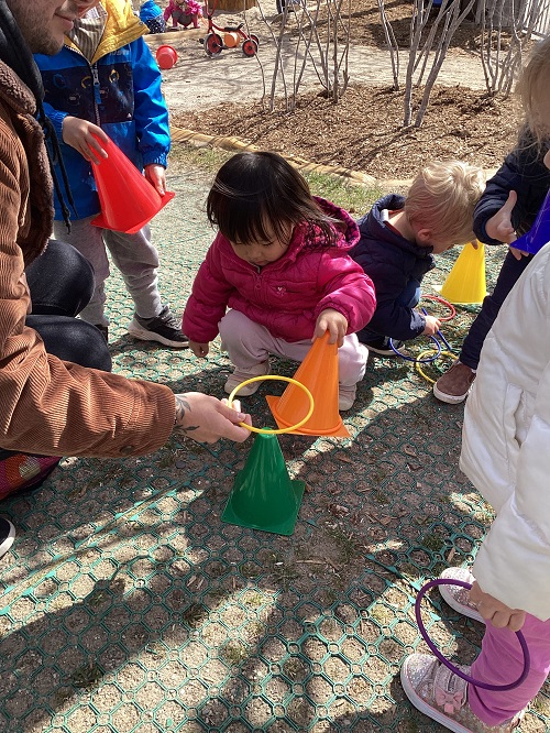 children stacking rings on the playground