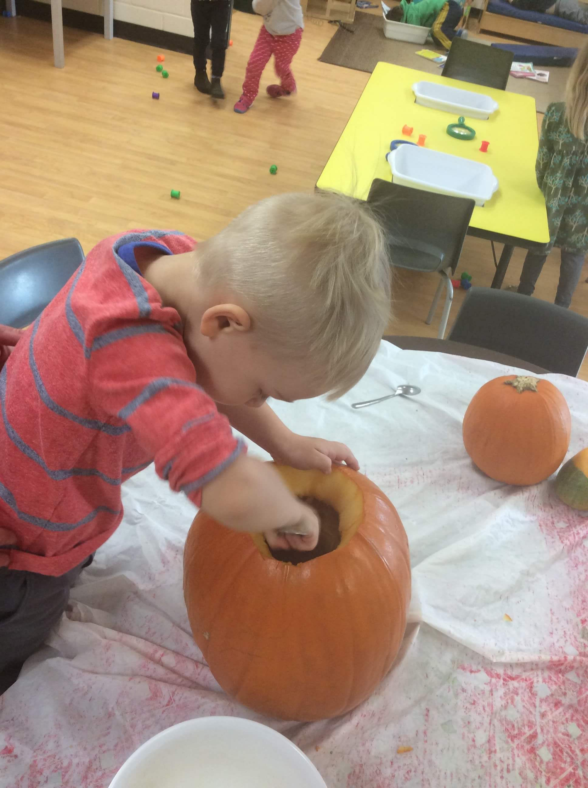 boy carving a pumpkin