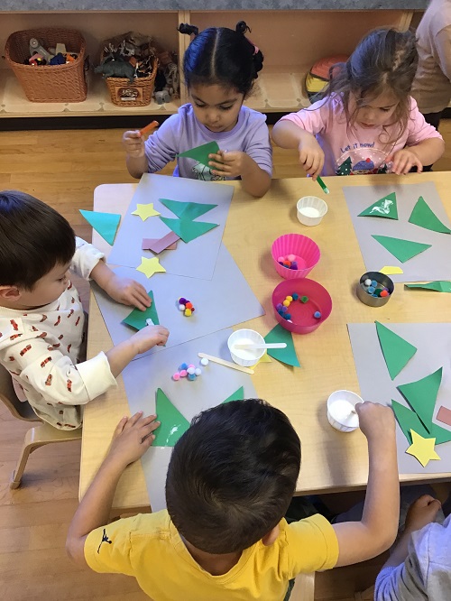 Children creating pictures out of shapes and other materials.