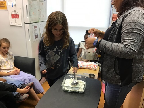 Child mixing melted marshmallows