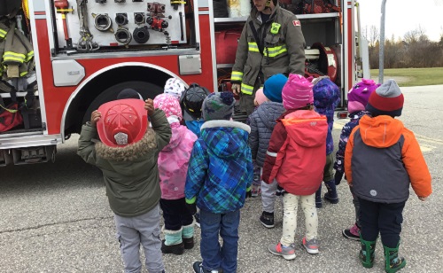 Children listening to Fire fighter speak. 