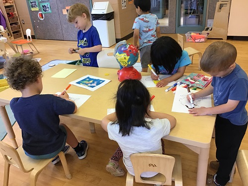 Children colouring pictures of continents.