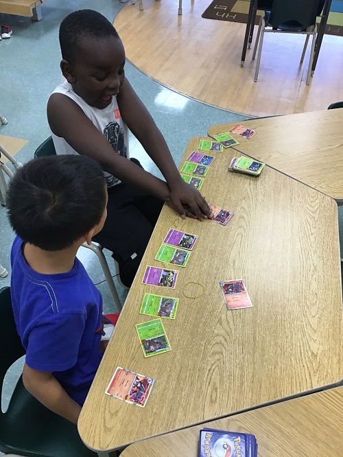 Children playing with Pokémon Cards