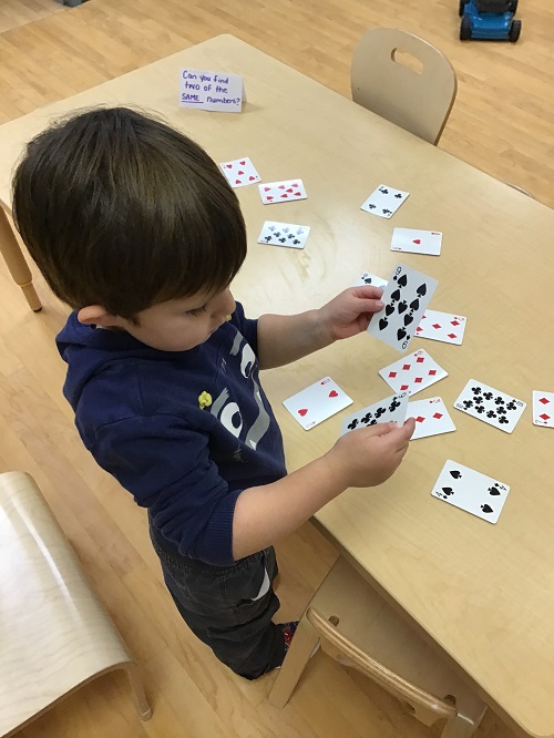 Child flipping over cards.