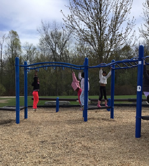 Children practicing on the monkey bars.