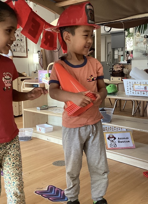 Preschool children pretending to be firefighters