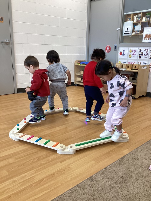 Children exploring on a balance beam.