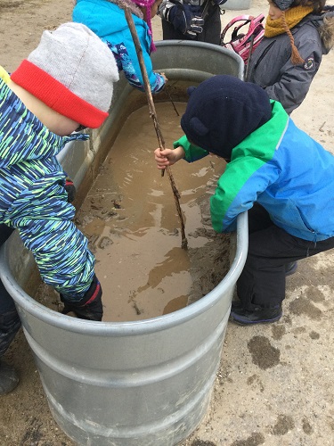 Children exploring mud