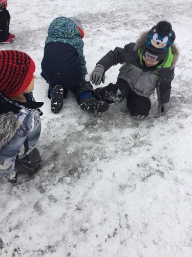 Children sliding on a patch of ice